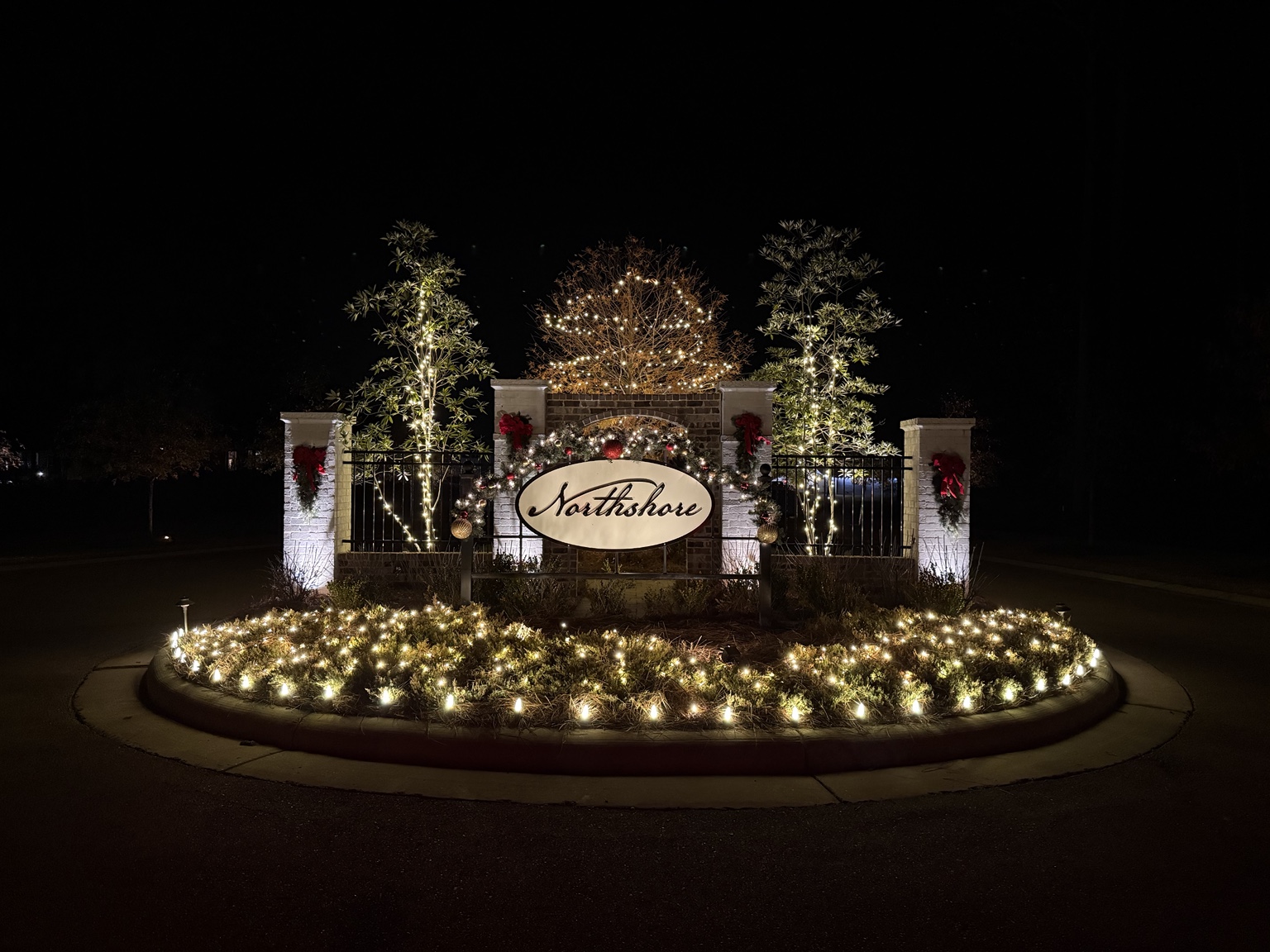 Holiday lighting at a neighborhood entrance